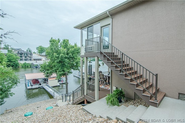 view of property exterior featuring a boat dock and a water view