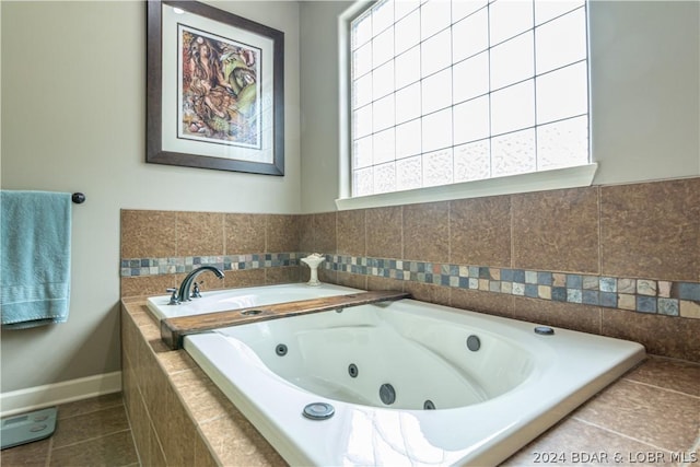 bathroom featuring tile patterned flooring and tiled bath