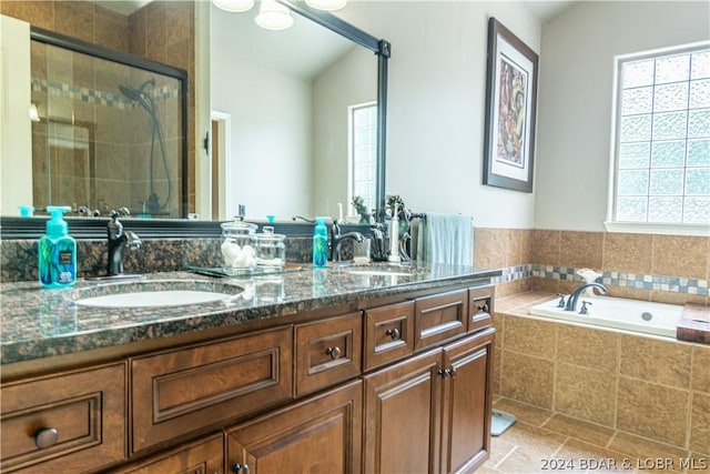 bathroom with vaulted ceiling, vanity, tile patterned floors, and independent shower and bath