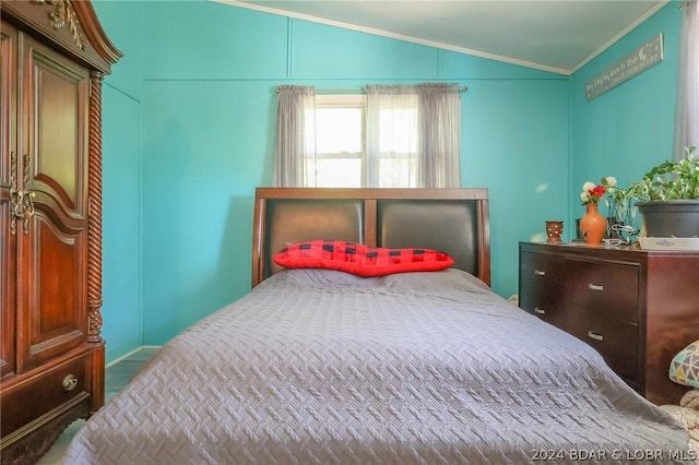 bedroom with vaulted ceiling and crown molding