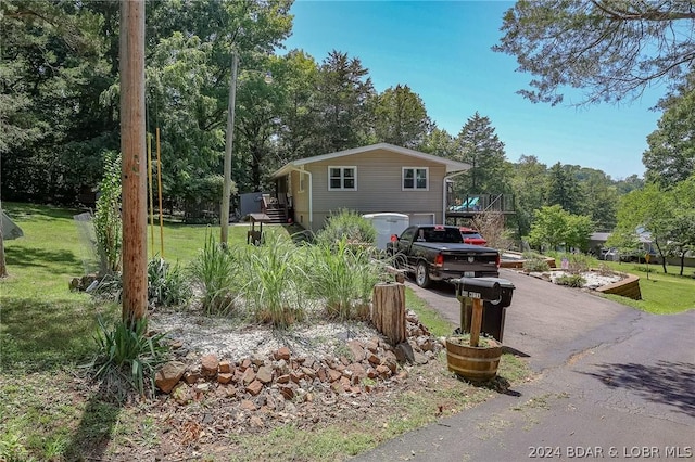 view of side of home with a yard and a garage