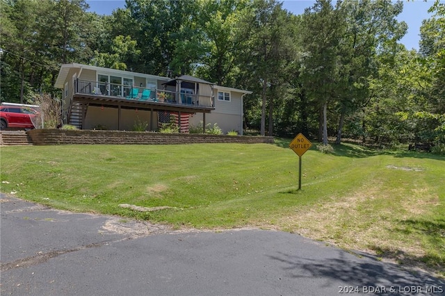 view of front of house with a front yard and a wooden deck