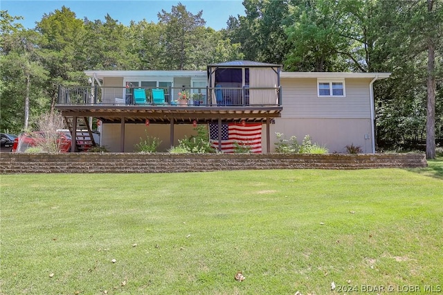 back of house with a lawn, a wooden deck, and a gazebo