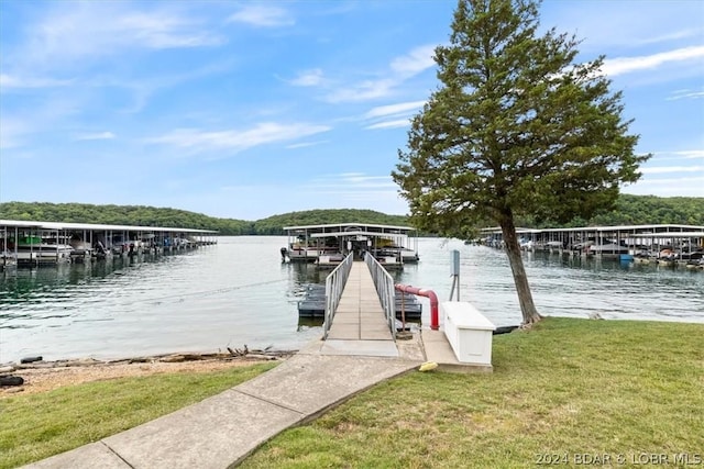 dock area featuring a lawn and a water view