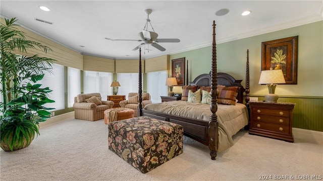 carpeted bedroom featuring ceiling fan and ornamental molding