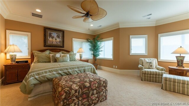 bedroom featuring ceiling fan, crown molding, and light colored carpet