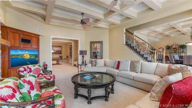 living room featuring ceiling fan, light colored carpet, coffered ceiling, and beamed ceiling