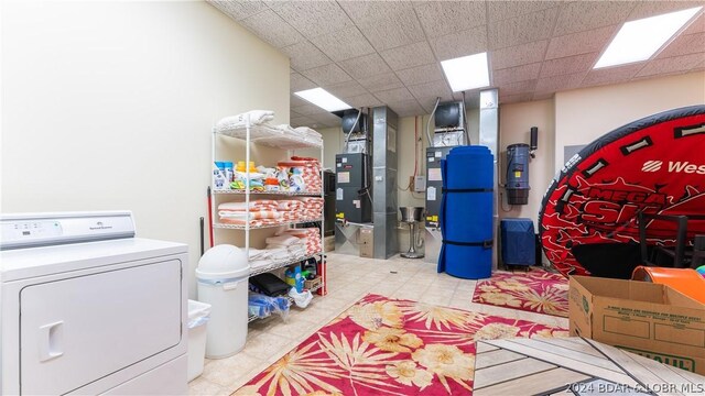 storage room featuring heating unit and washer / dryer