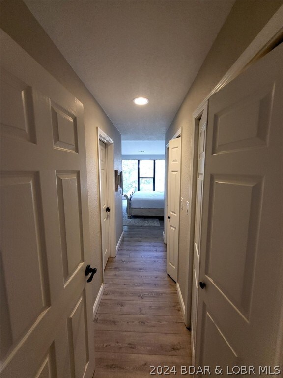 hall with light hardwood / wood-style floors