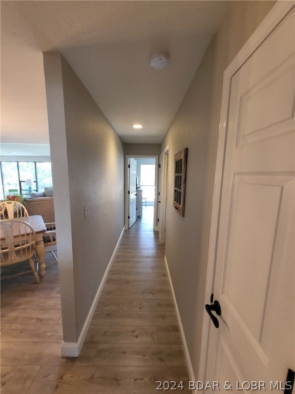 corridor with hardwood / wood-style floors