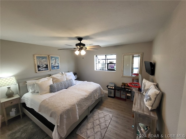 bedroom with ceiling fan and hardwood / wood-style floors