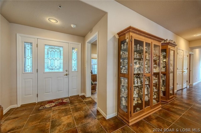 entryway with a textured ceiling