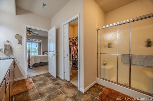 bathroom featuring ceiling fan, vanity, and a shower with shower door