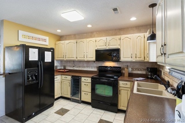 kitchen with black appliances, tasteful backsplash, light tile patterned floors, sink, and wine cooler