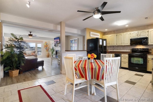 kitchen with ceiling fan, light tile patterned flooring, a textured ceiling, black appliances, and decorative backsplash