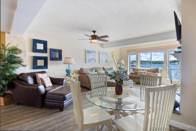 dining room featuring hardwood / wood-style floors, a textured ceiling, and ceiling fan