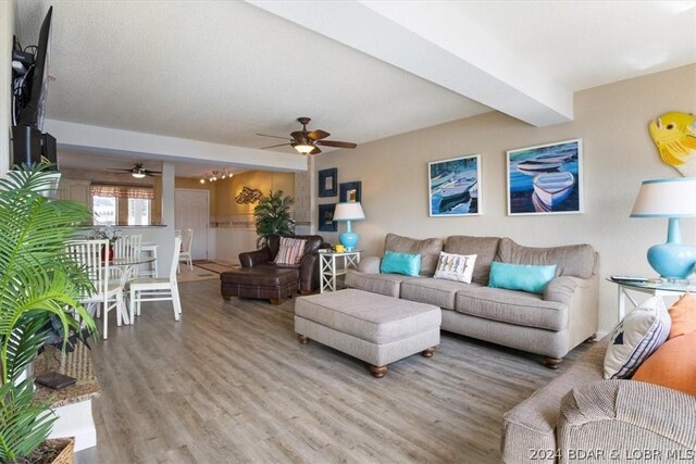 living room featuring ceiling fan and light hardwood / wood-style flooring