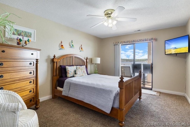 carpeted bedroom featuring ceiling fan and a textured ceiling