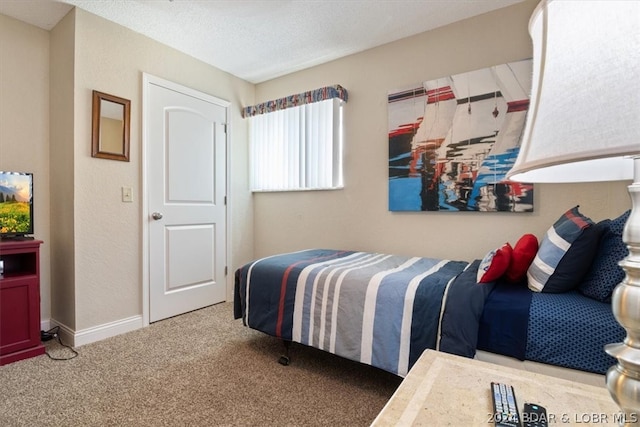 bedroom featuring light colored carpet and a textured ceiling