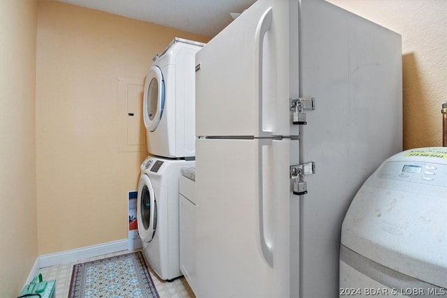 clothes washing area featuring stacked washer and clothes dryer