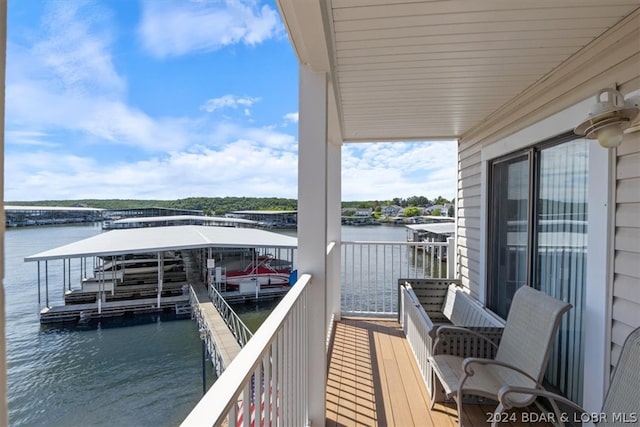 balcony with a water view and a boat dock