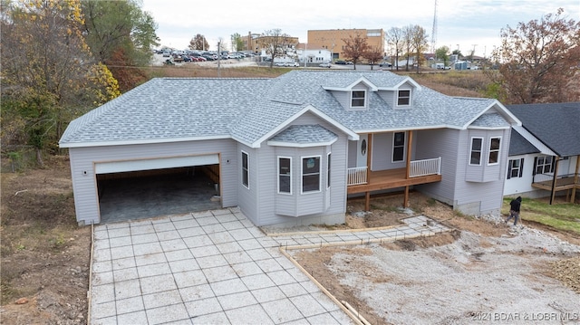 view of front of property featuring a porch and a garage