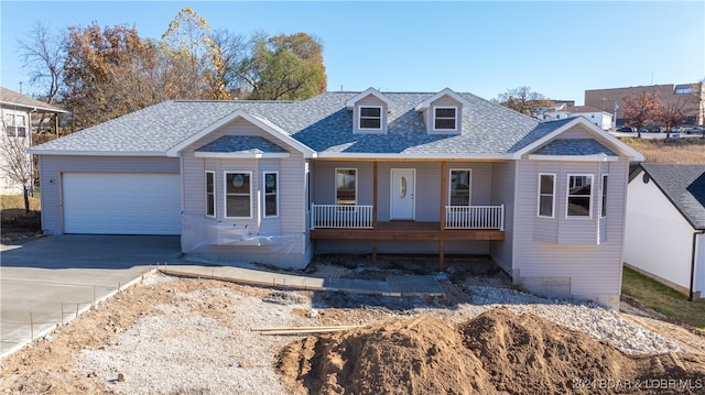 view of front facade with covered porch and a garage