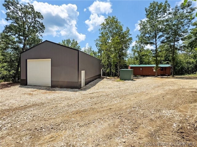 exterior space featuring an outbuilding and a garage