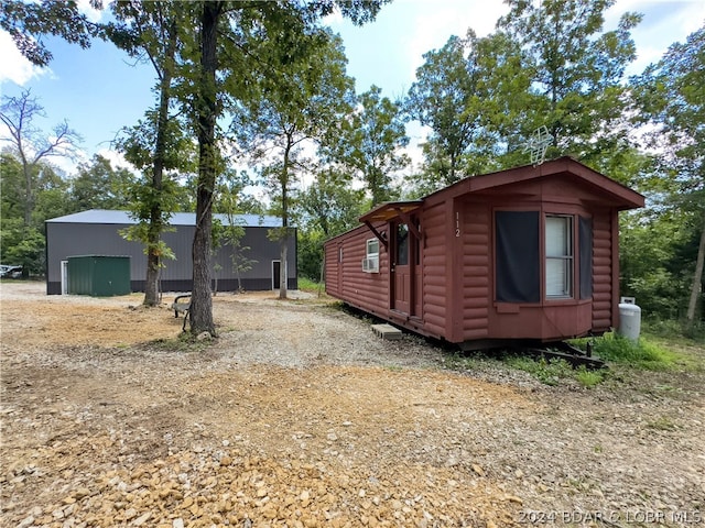 view of home's exterior with an outdoor structure