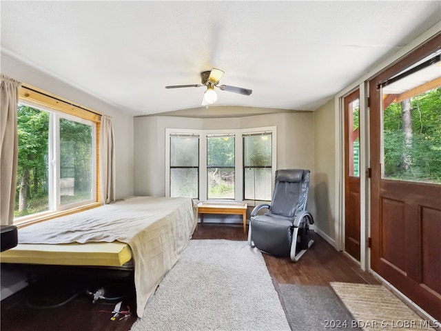 bedroom with ceiling fan, dark wood-type flooring, and lofted ceiling