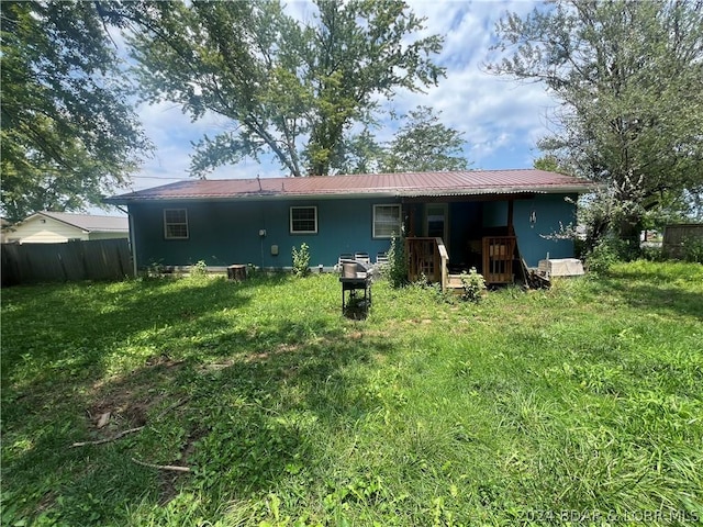 rear view of house with a yard