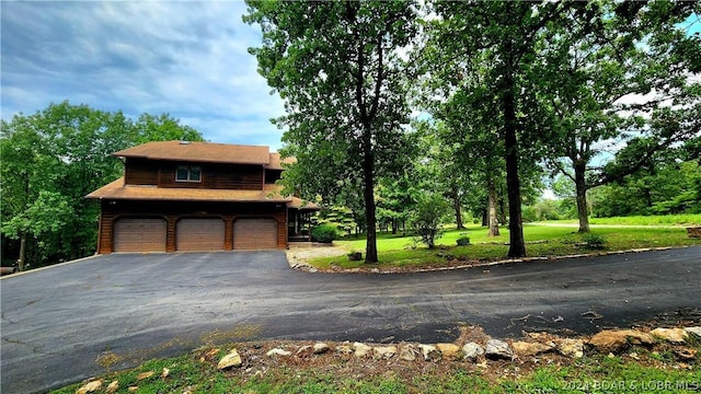 exterior space featuring a garage and a front yard