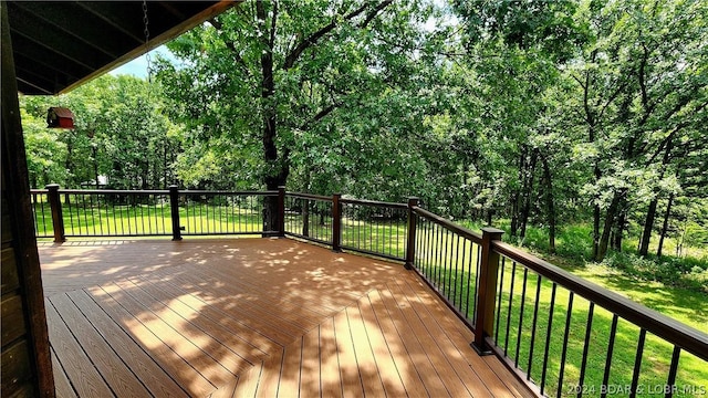 wooden terrace with a lawn