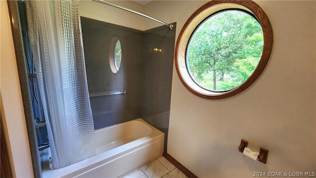 bathroom with shower / bath combination with curtain