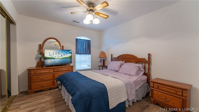 bedroom with a closet, ceiling fan, and hardwood / wood-style flooring