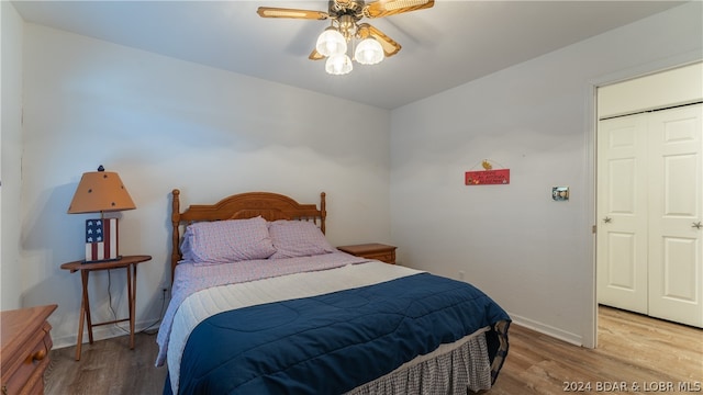 bedroom featuring wood-type flooring, a closet, and ceiling fan