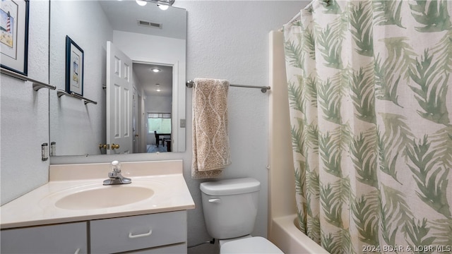 full bathroom with vanity, toilet, and shower / tub combo with curtain