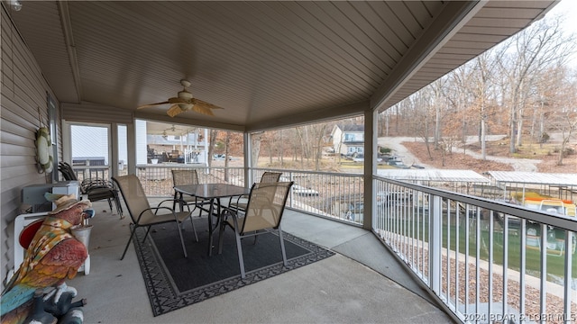 view of patio featuring ceiling fan and a balcony