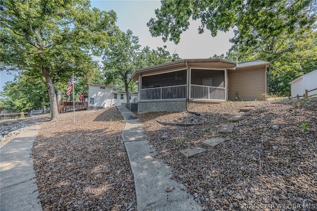 rear view of property with ceiling fan