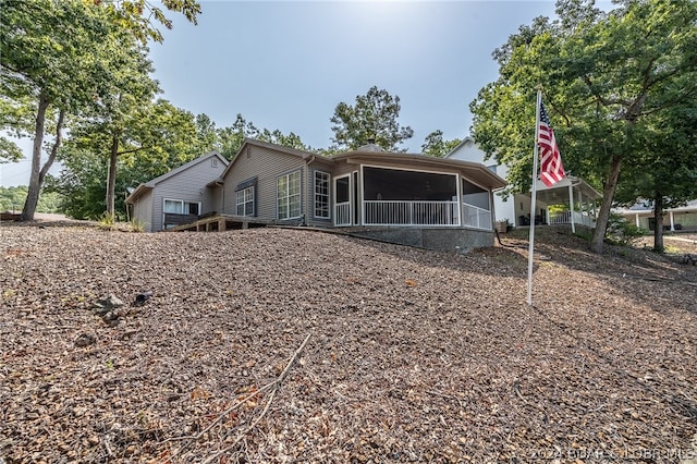 view of front of home featuring a sunroom