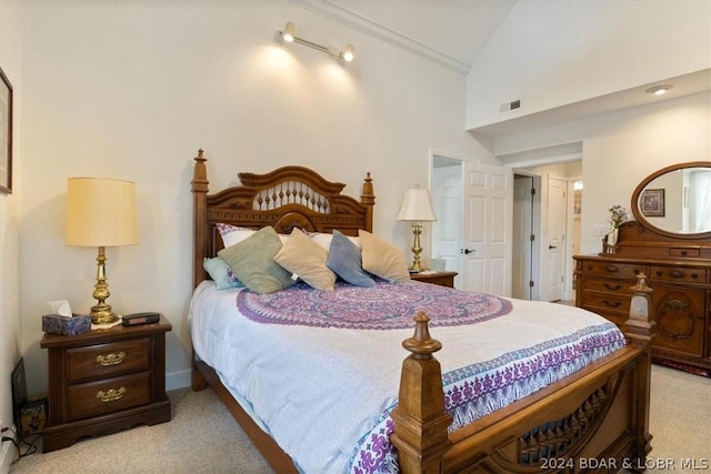 bedroom with high vaulted ceiling, ornamental molding, and light colored carpet