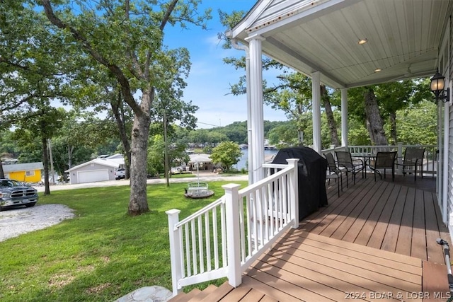 deck with covered porch and a lawn