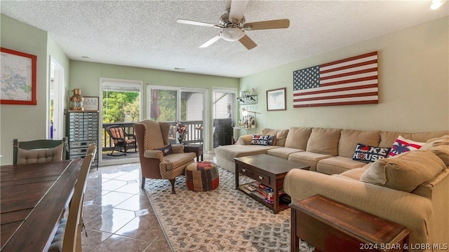 tiled living room featuring a textured ceiling and ceiling fan