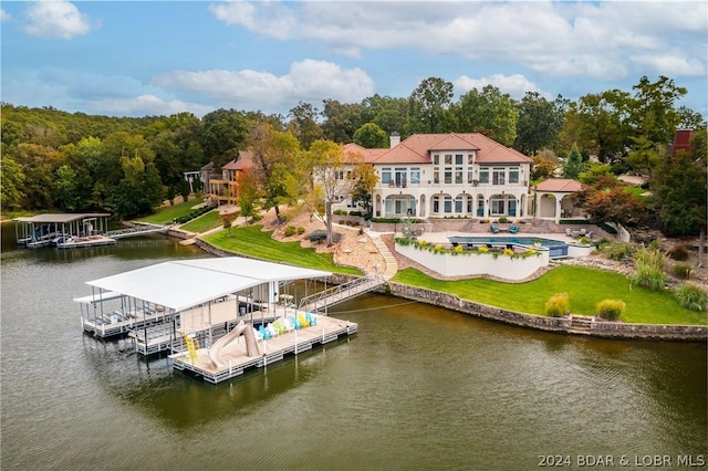 rear view of house featuring a water view