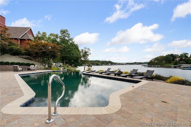 view of pool featuring a water view and a patio area