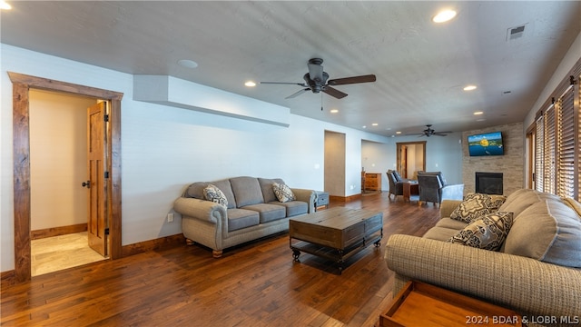 living room with hardwood / wood-style flooring, a fireplace, and ceiling fan