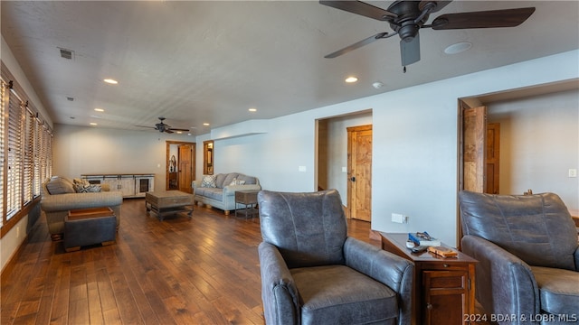 living room with dark hardwood / wood-style floors and ceiling fan