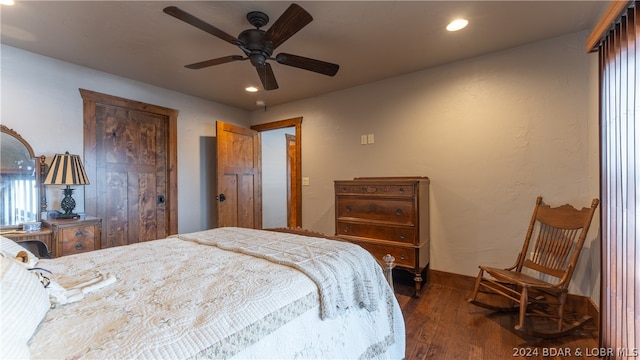 bedroom featuring dark wood-type flooring, multiple windows, and ceiling fan