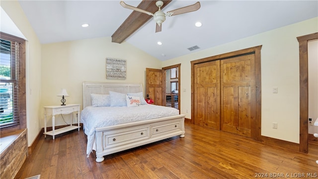 bedroom featuring lofted ceiling with beams, multiple windows, ceiling fan, and wood-type flooring