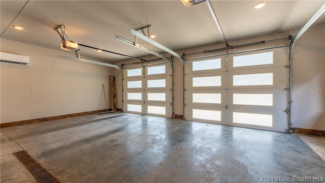 garage with a garage door opener and a wall unit AC